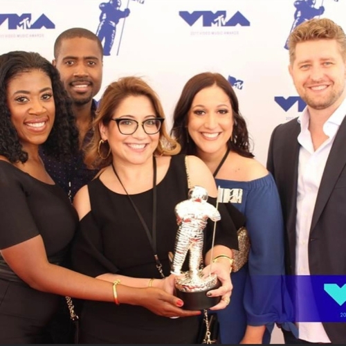 Trying to be an inspiring leader_five MTV employees at the VMAs holding a moon man award statue.