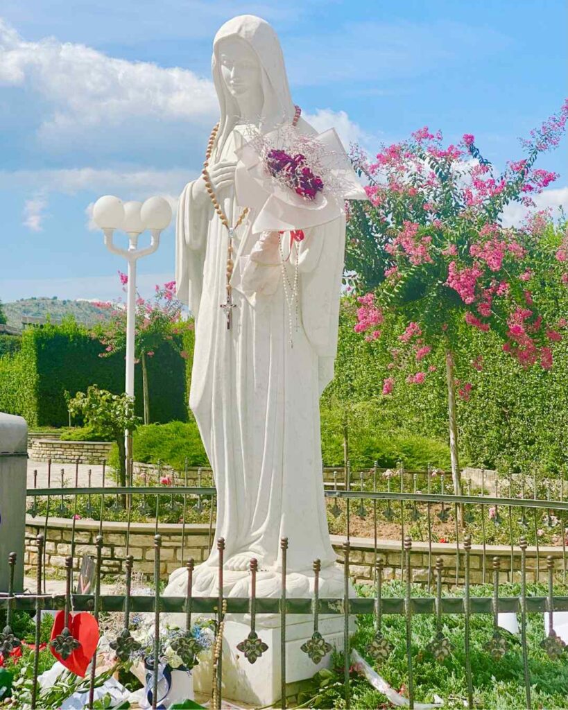 A Statue of the Virgen Mary in front of Saint James Church in Medjugorje