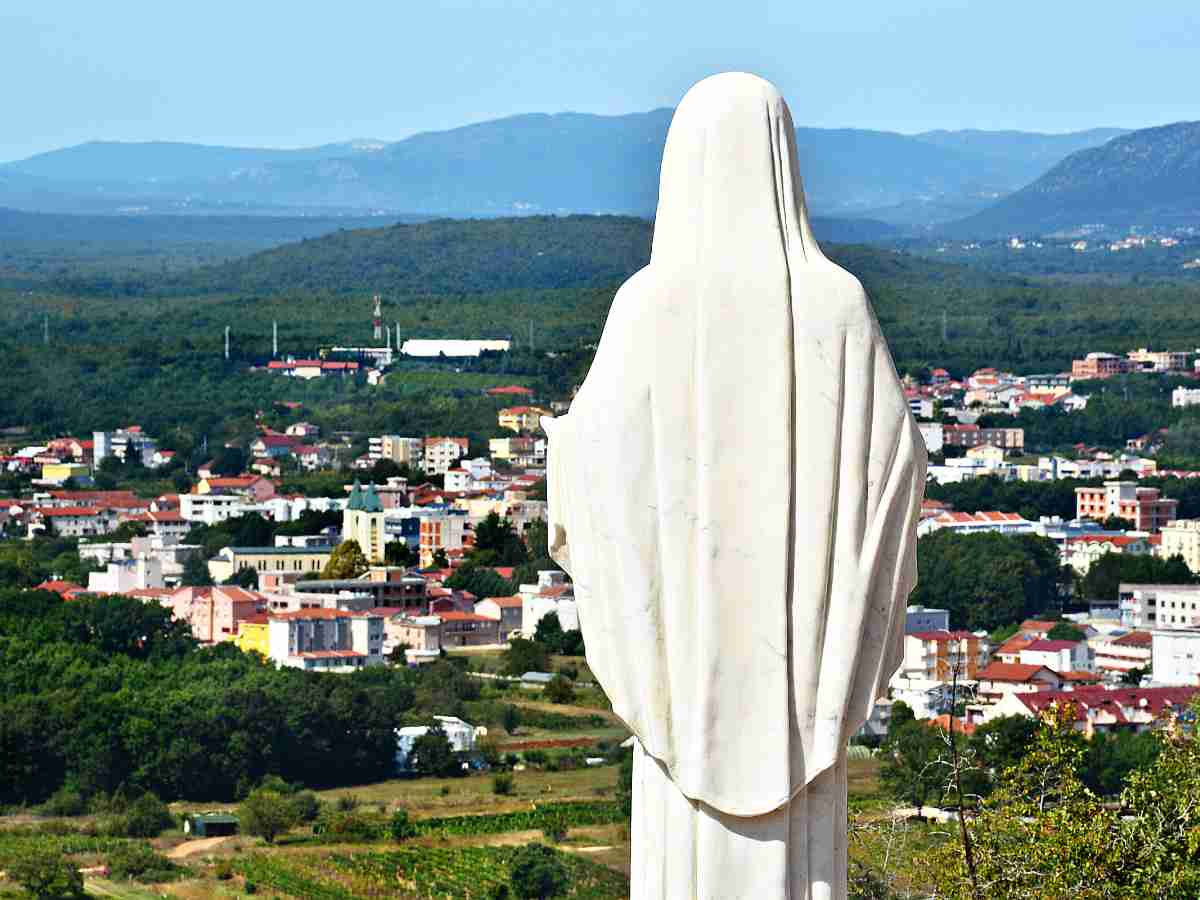 A statue of the Virgin Mary above Apparition Hill in Medjugorje.