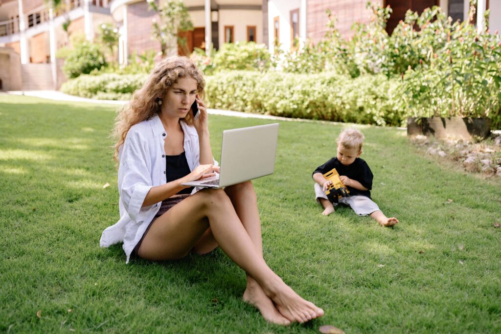 Woman coaching online outside with her son.